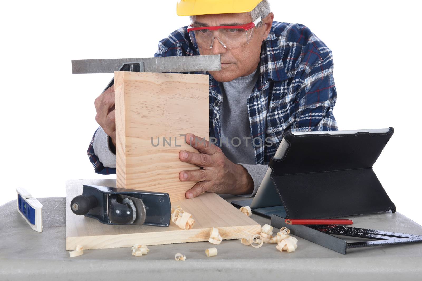 Closeup of a woodworker checking the squareness of a piece of wood.