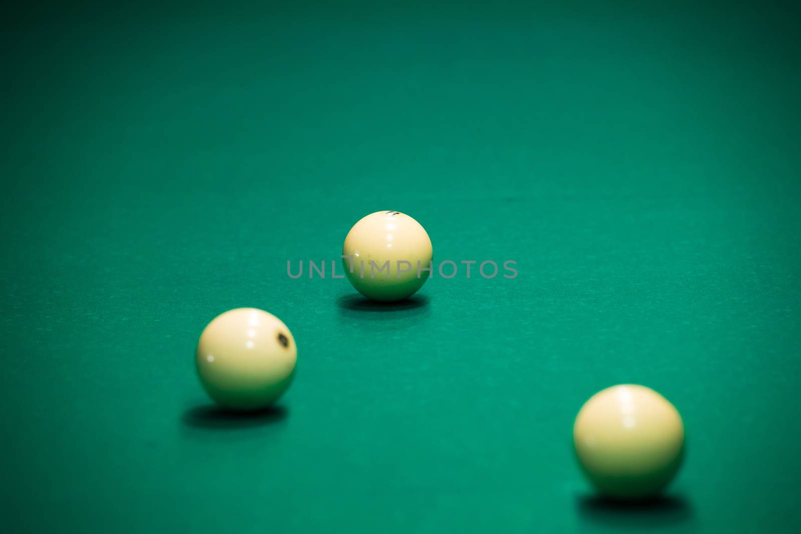 Sports game of billiards on a green cloth. Billiards white billiard balls close up
