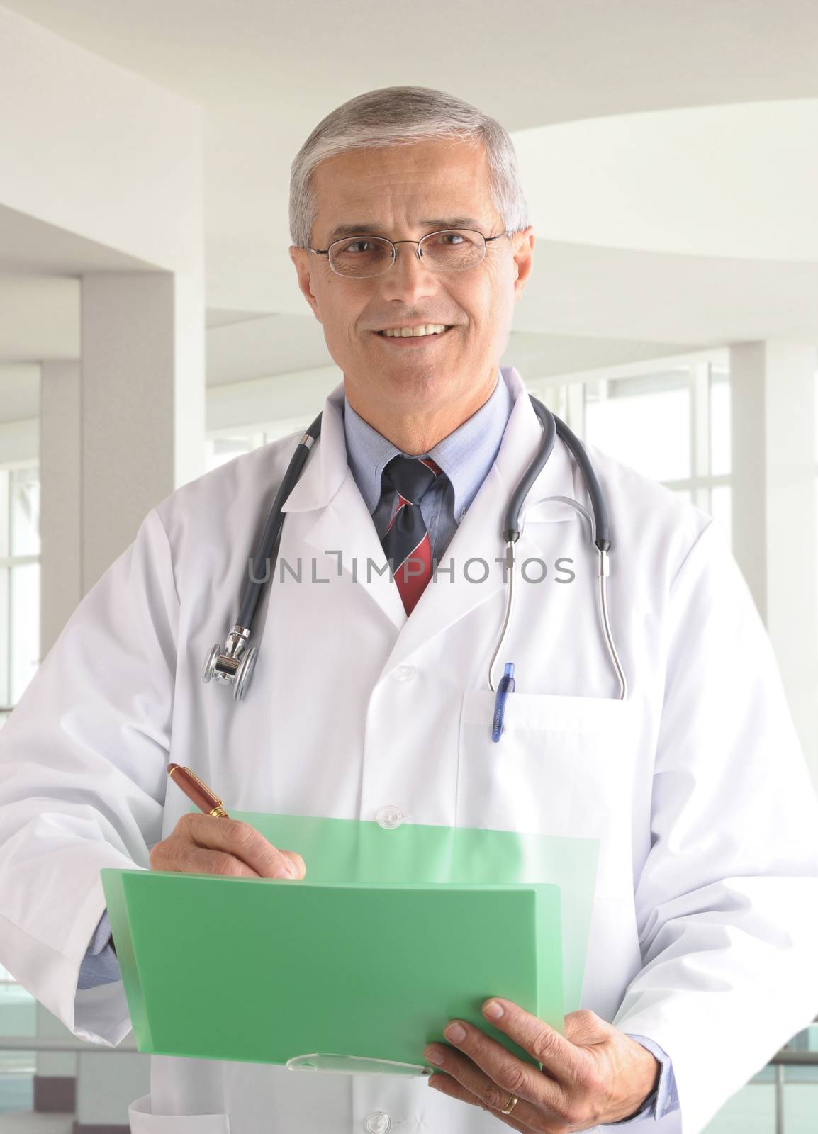 Middle aged doctor writing in chart in modern medical facility