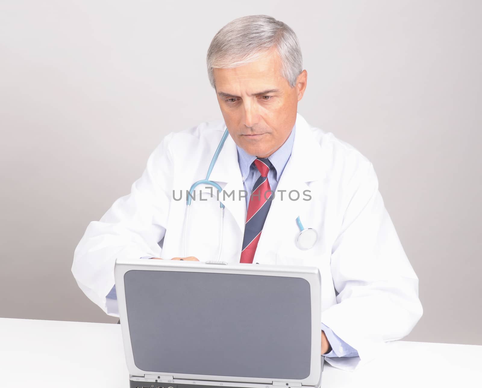Doctor at Desk with Computer by sCukrov