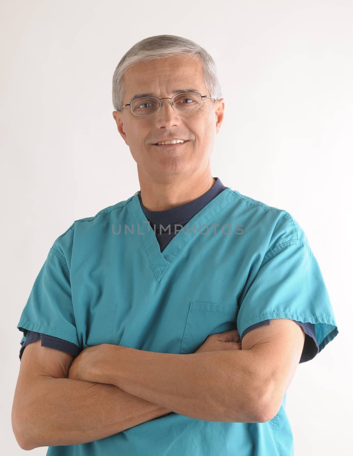 Smiling Middle Aged  Doctor with Arms Crossed over a gray background