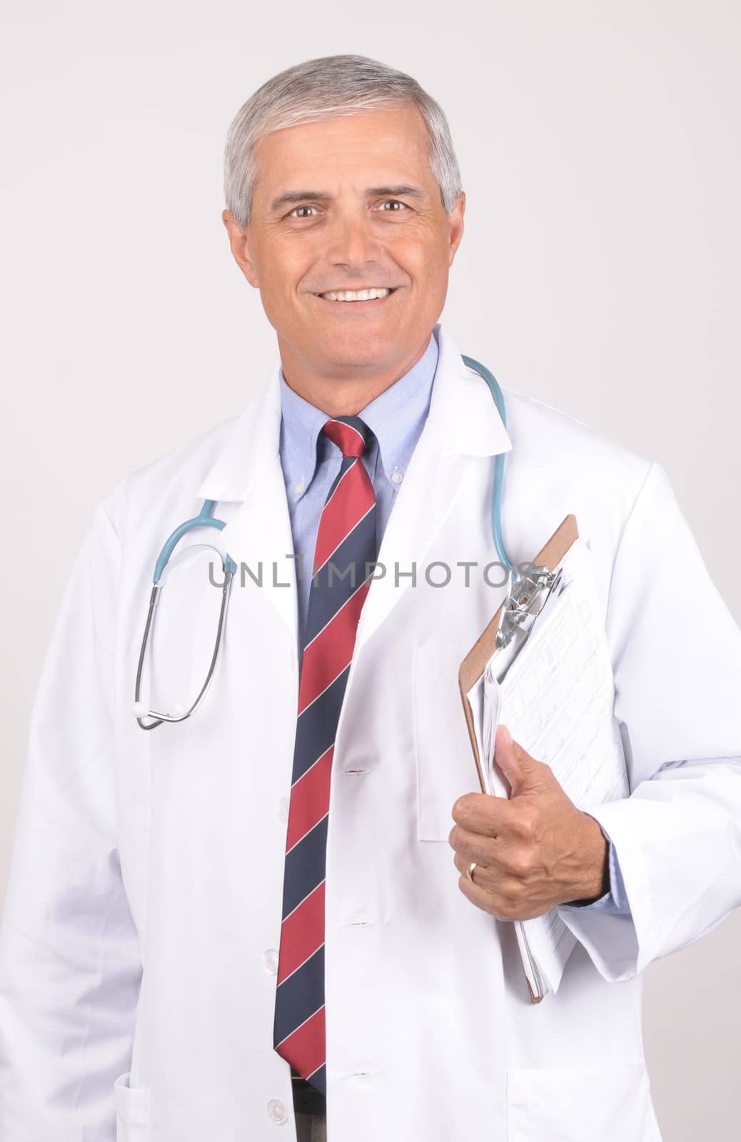 Portrait of a Middle Aged  Male Doctor in Lab Coat with Stethoscope and Clip Board