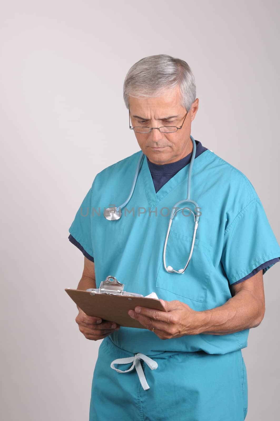 Doctor in Scrubs with clipboard by sCukrov