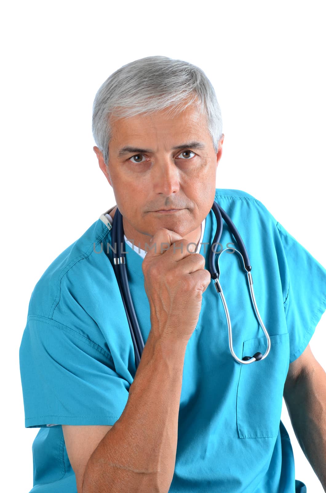 Serious middle aged doctor with his hand on his chin, Man is wearing scrubs with a stethoscope around his neck. Vertical Format over white.