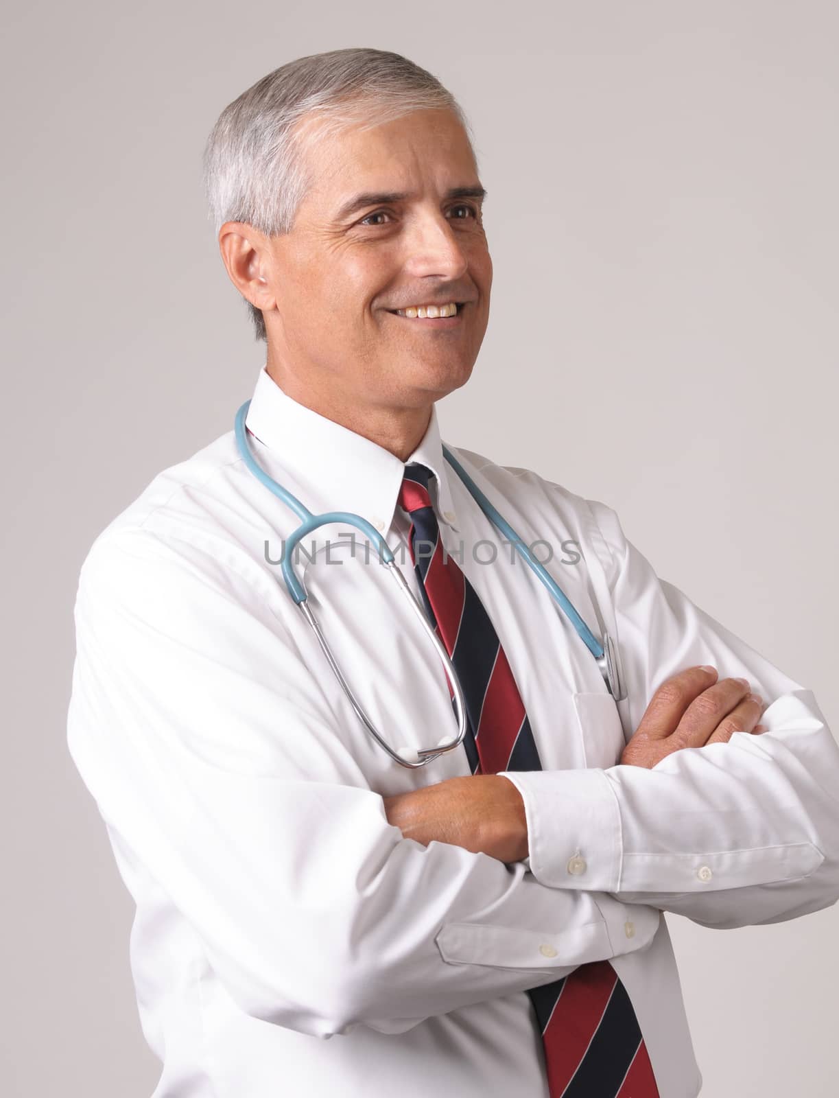 Profile Portrait of Smiling Middle Aged  Doctor with Stethoscope and arms crossed