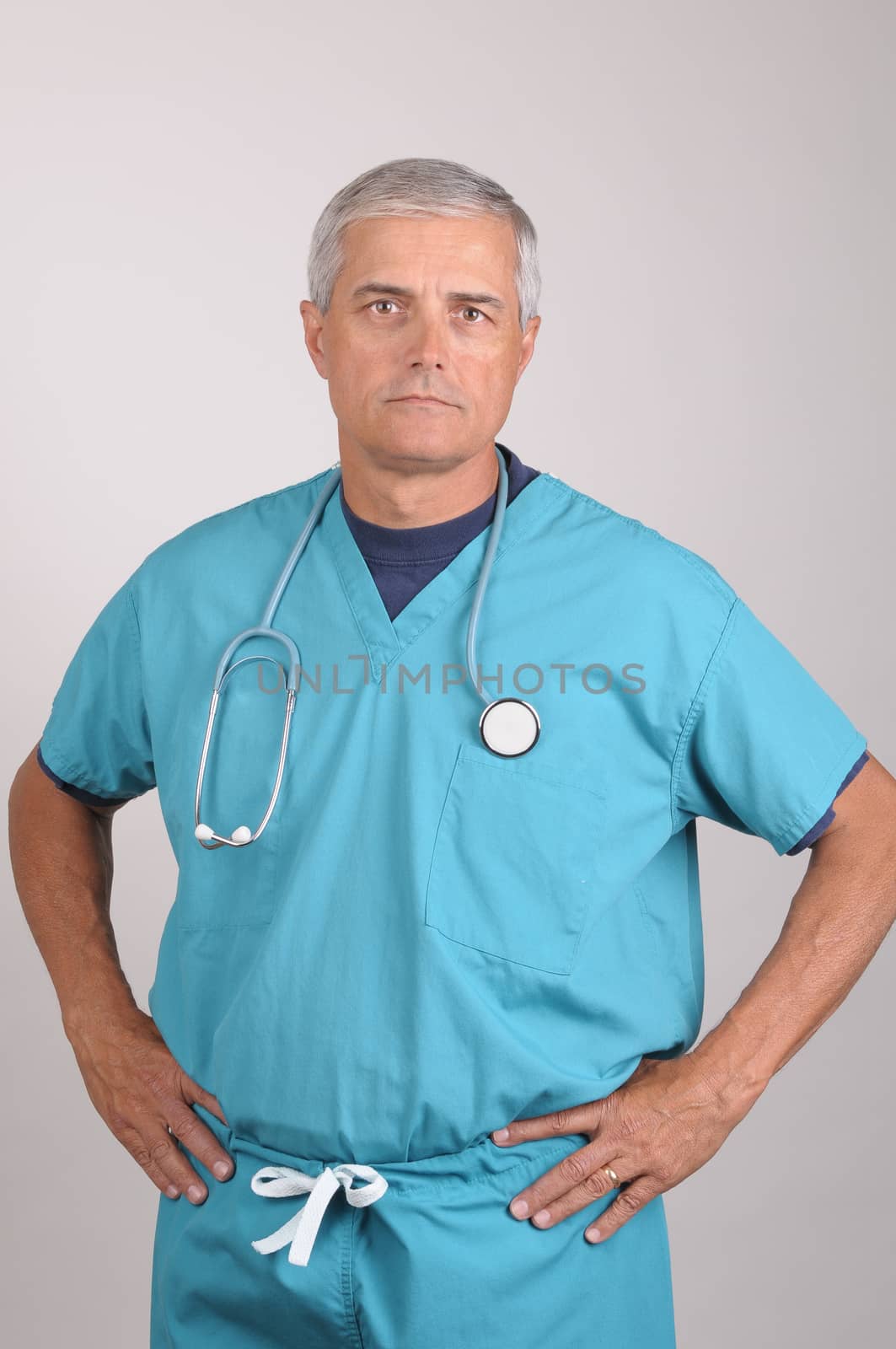 Doctor in Scrubs with Hands on Hips by sCukrov