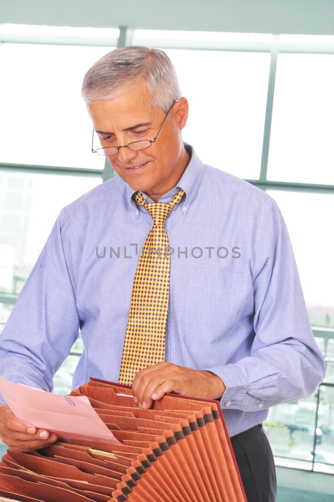 Middle aged Businessman with File Box by sCukrov