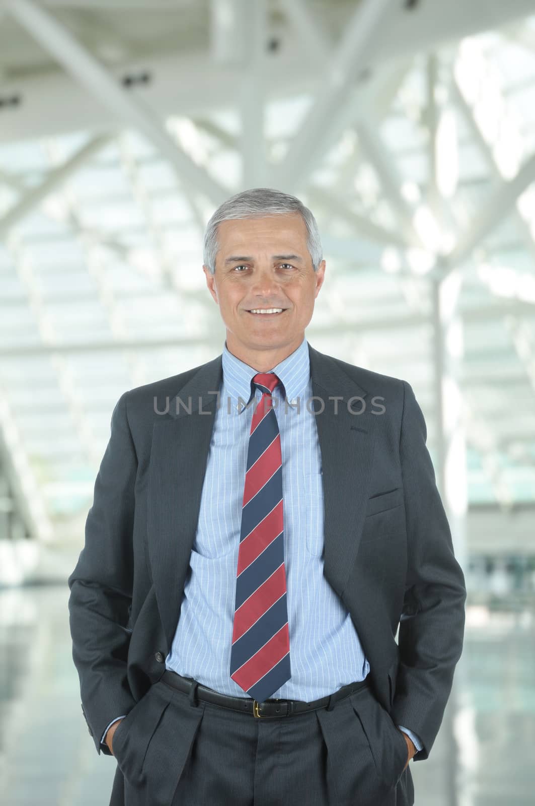 Middle aged Businessman in office lobby by sCukrov