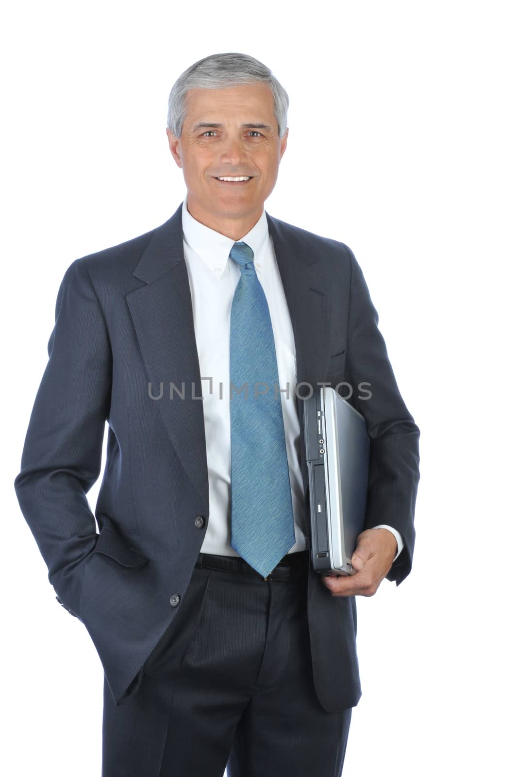 Businessman carrying Laptop Under His arm with hand in pocket isolated on white