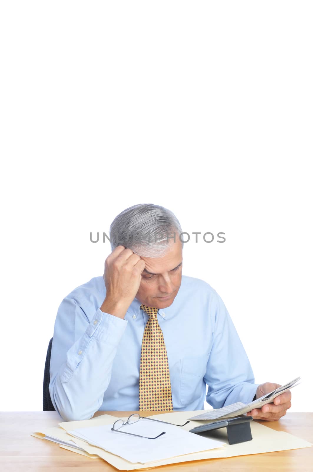Businessman Reading Newspaper at His Desk isolated on white