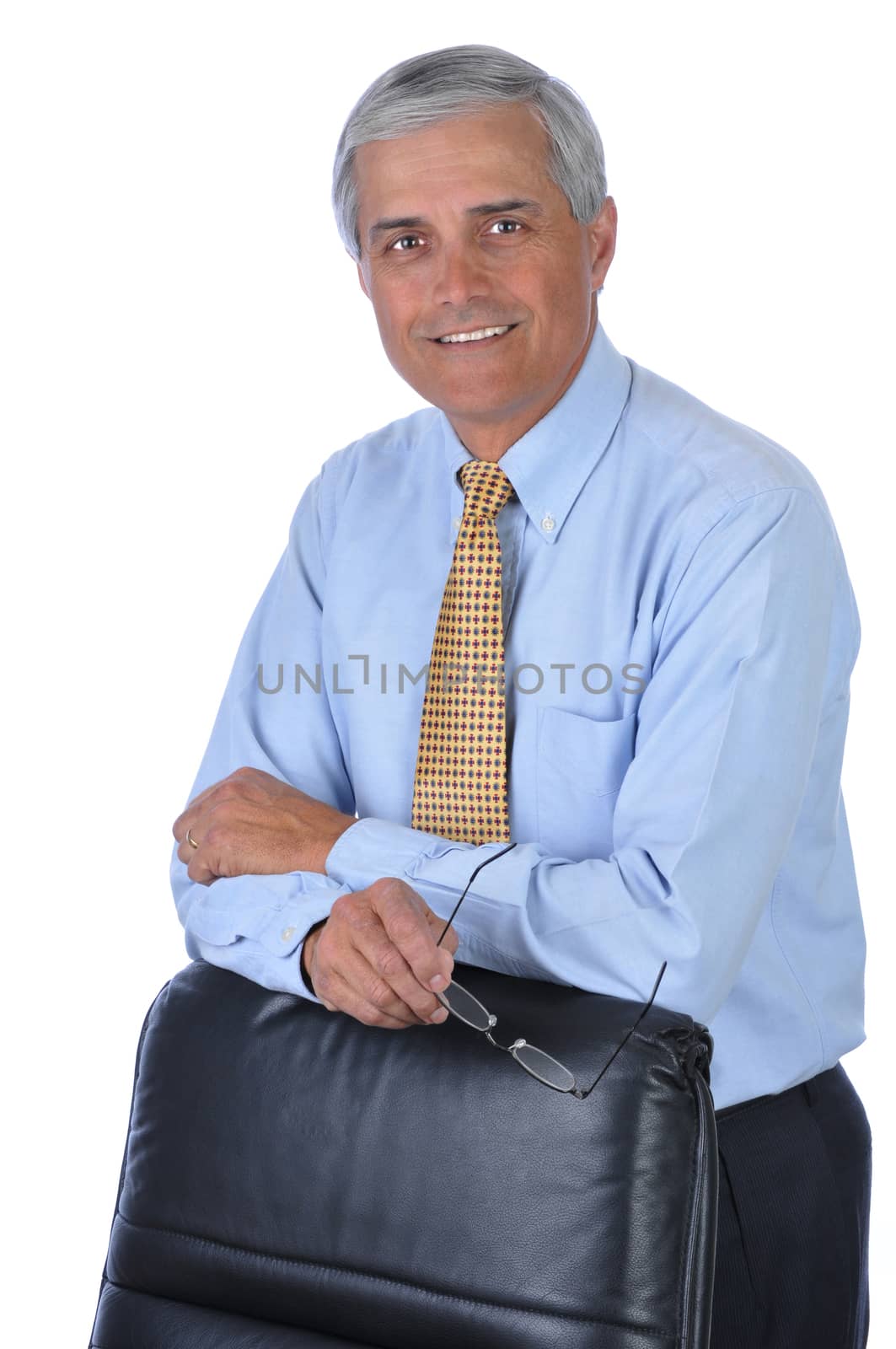 Businessman Holding Glasses Leaning on Back of Chair isolated over white