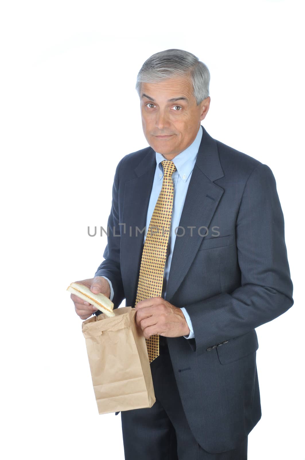 Businessman holding brown bag and sandwich isolated on white
