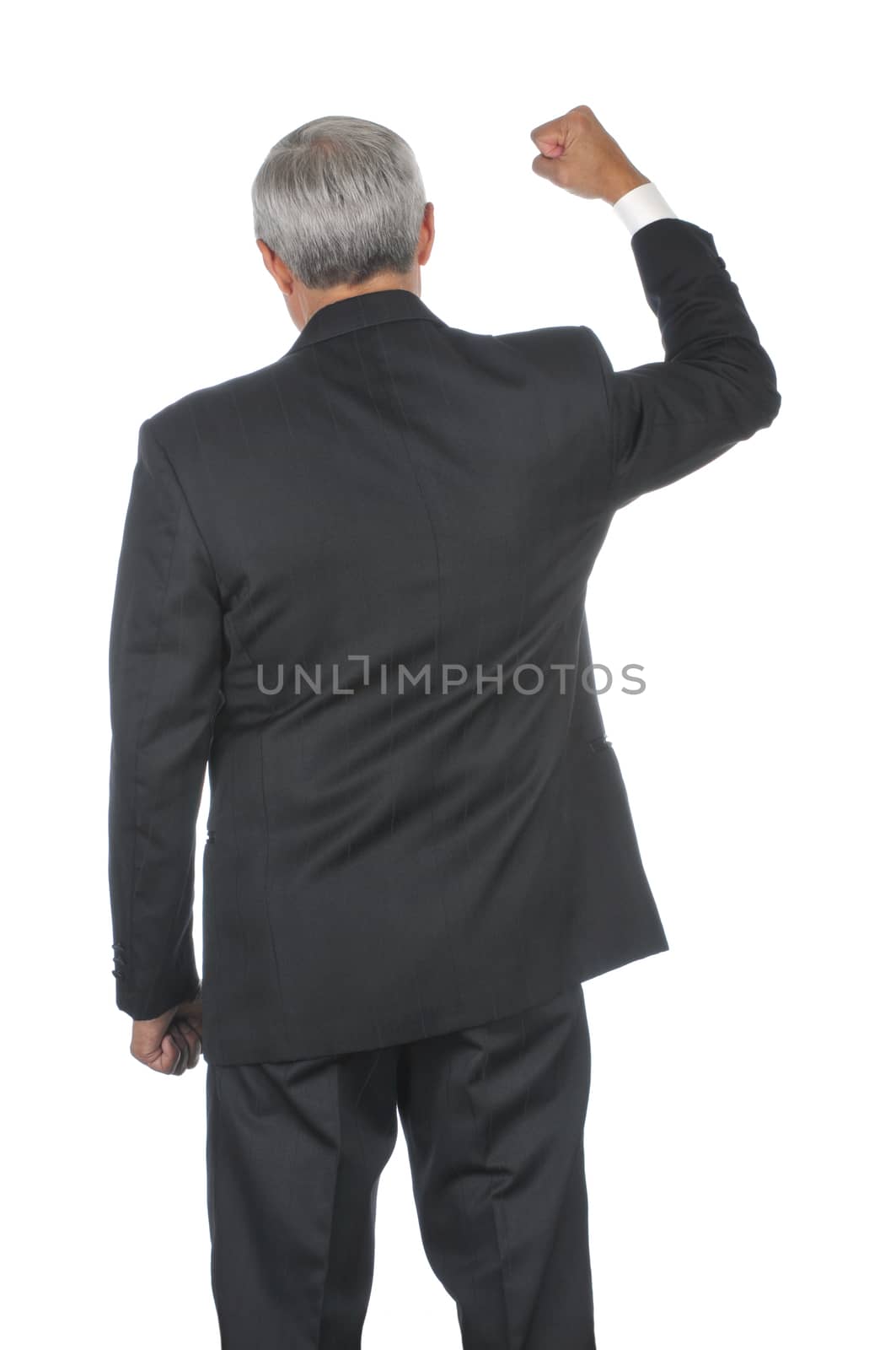 Middle Aged Businessman with one fist clenched and thrust into the air viewed from behind isolated on white vertical format