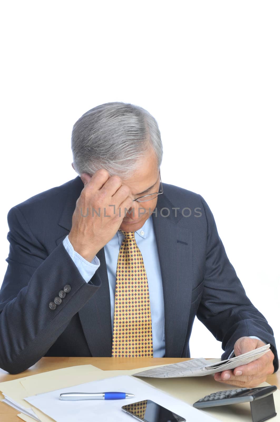 Businessman Seated at His Desk Reading Newspaper isolated on white