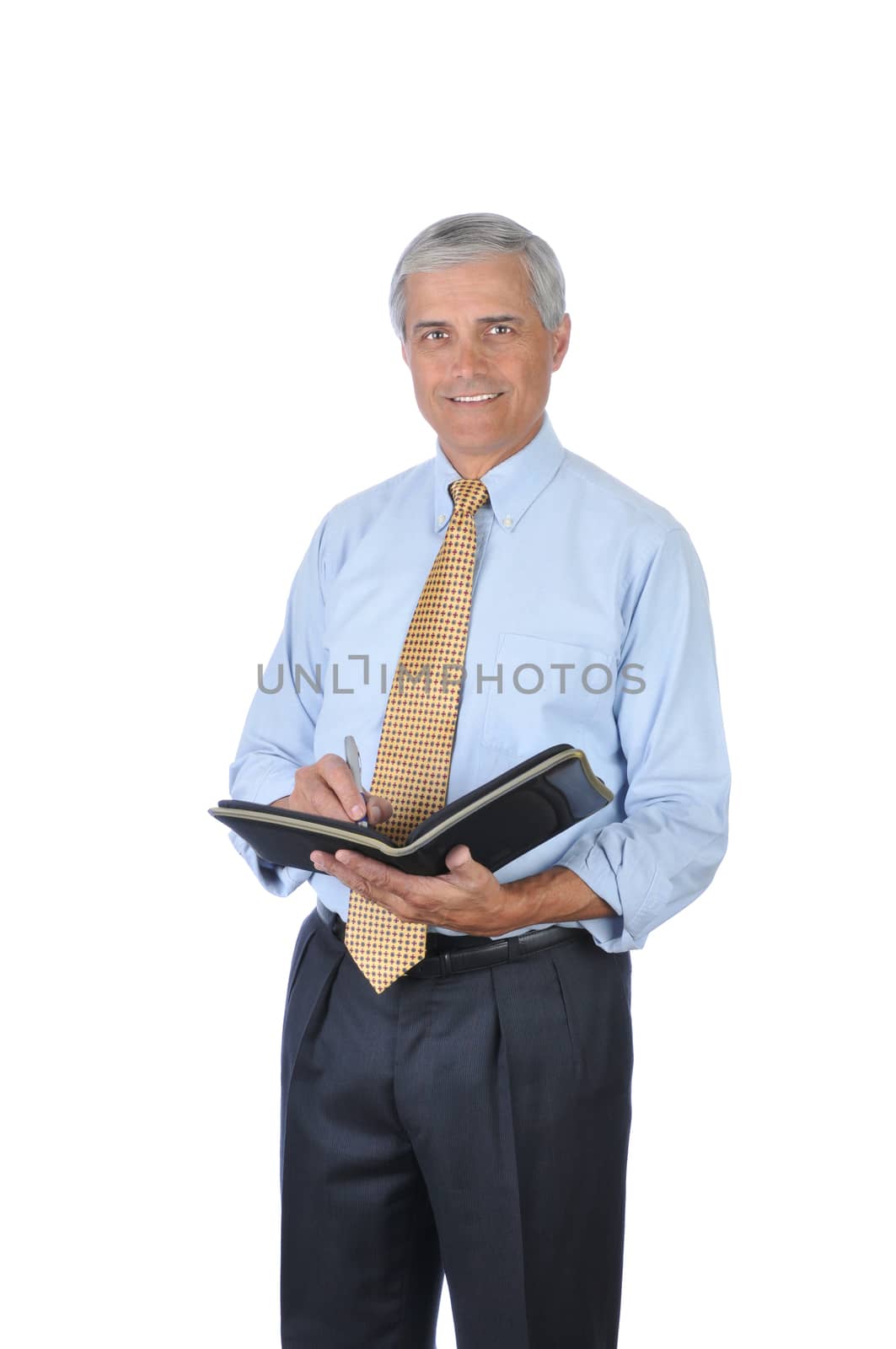 Smiling Middle Aged Businessman Writing in Notebook isolated on white