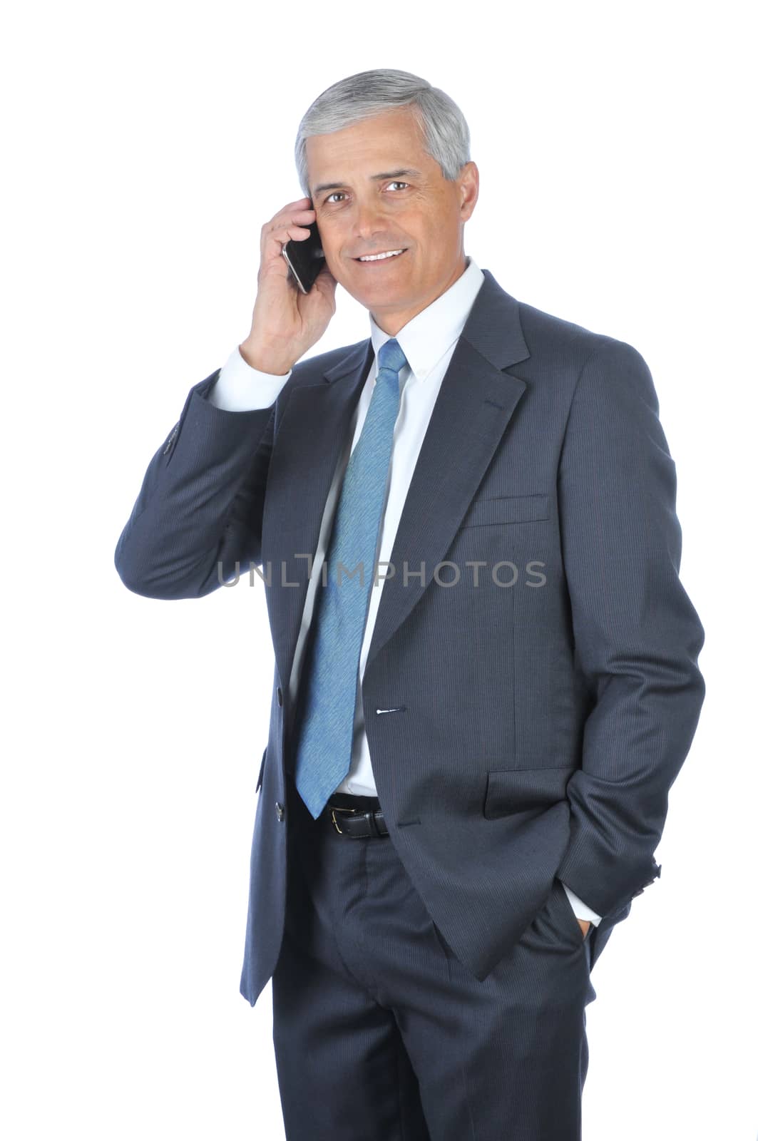 Smiling Businessman with one hand in pocket talking on cellphone isolated on white