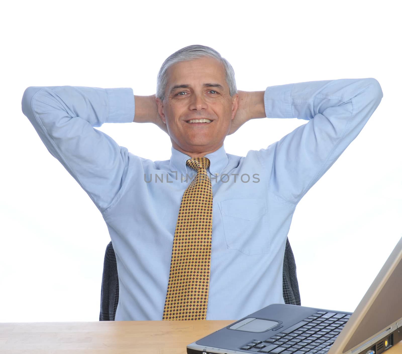 Man at Desk with hands behind his head by sCukrov