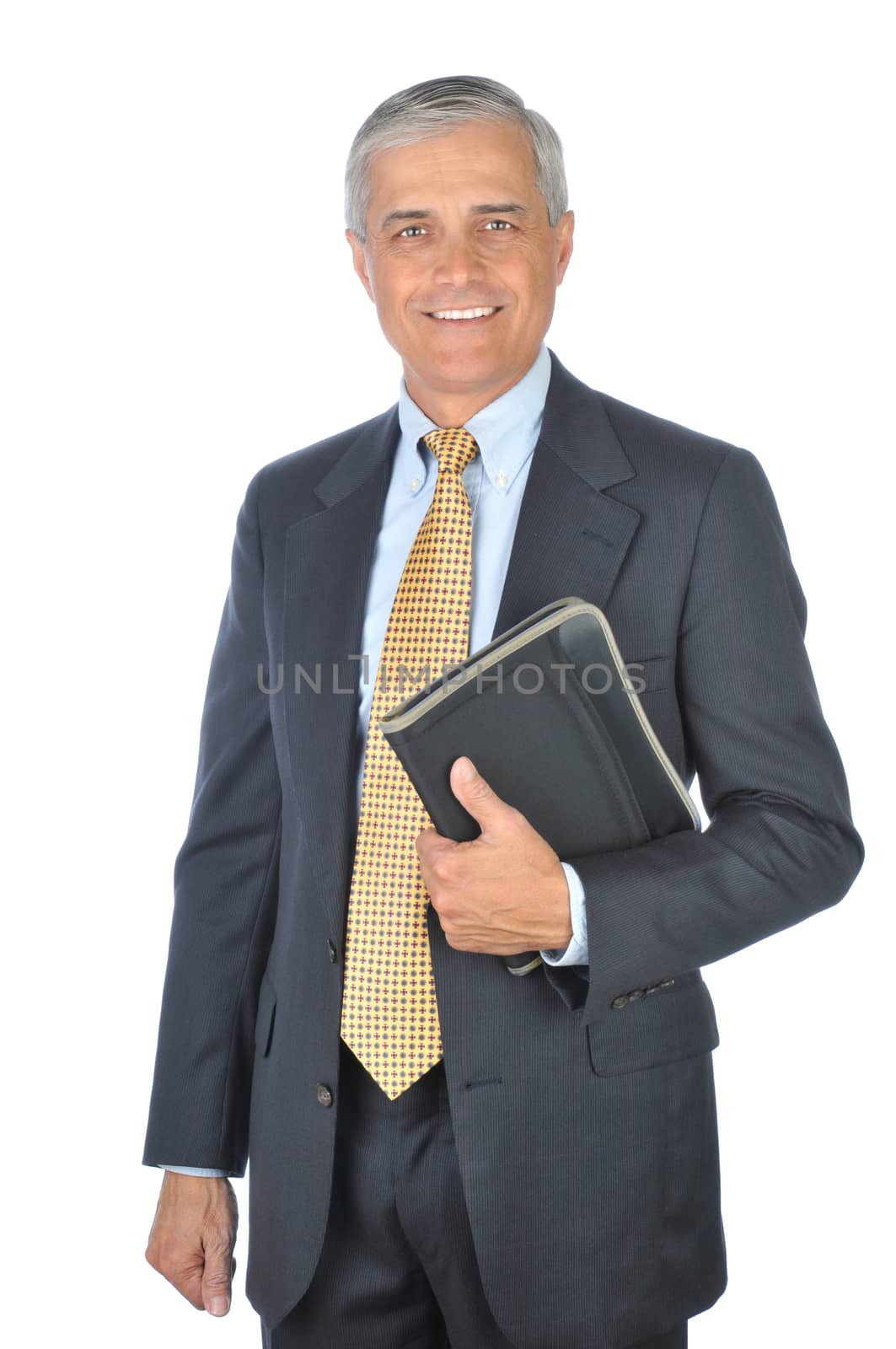 Smiling Middle aged Businessman in dark suit standing with notebook isolated on white