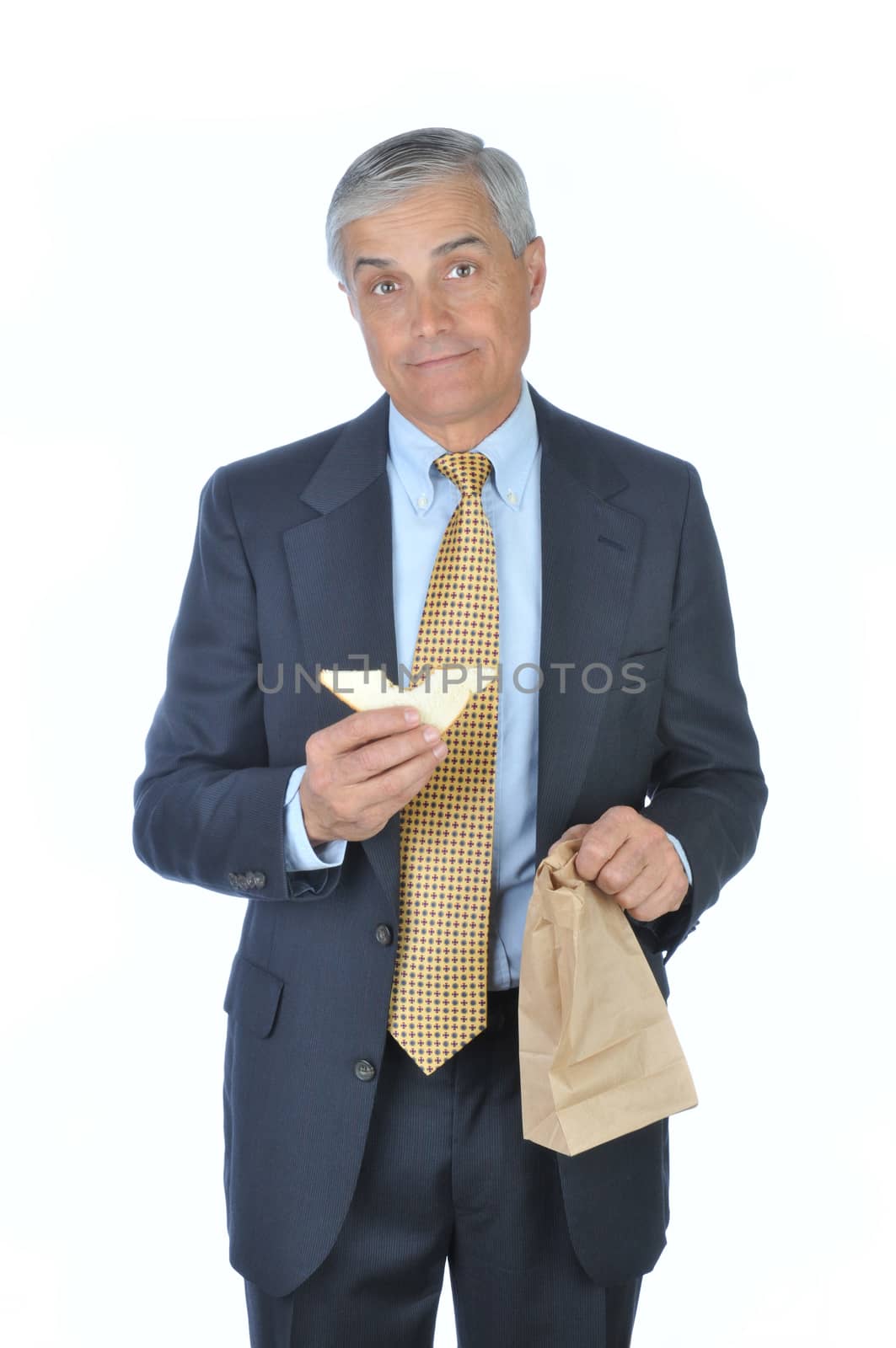 Businessman holding brown bag and sandwich isolated on white