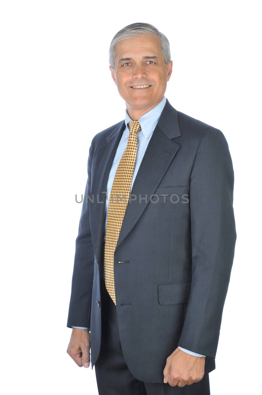 Smiling Businessman in dark suit standing with hsi arms at his side isolated on white
