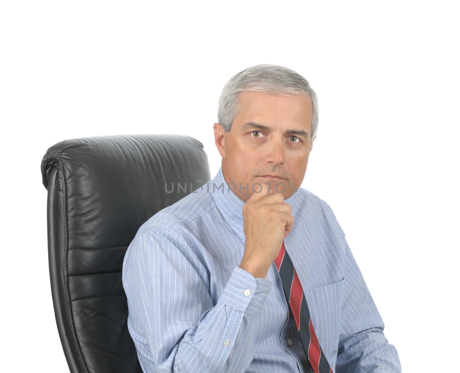 Portrait of a Serious Middle Aged Businessman sitting in office chair with hand on chin isolated over white