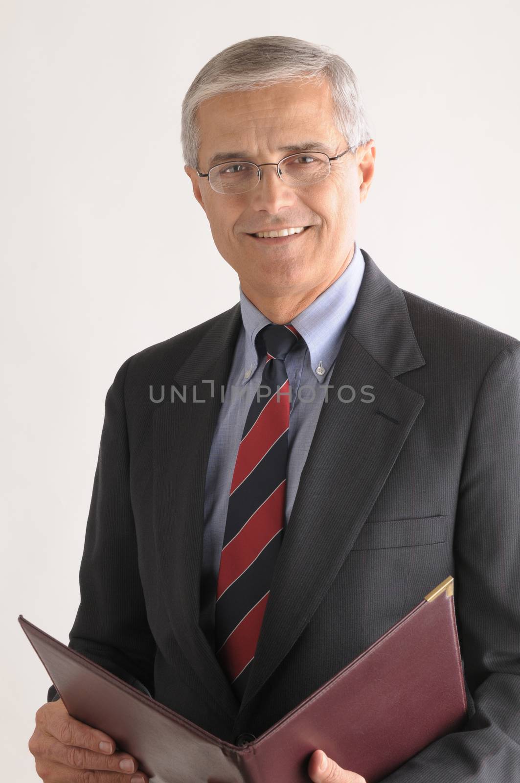 Middle Aged Businessman with Leather Folder over light gray background vertical format