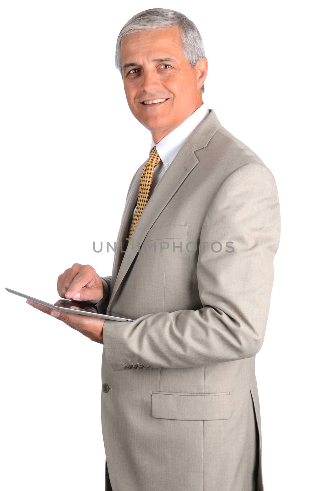 Portrait of a smiling middle aged businessman in a light suit with a tablet computer. Three quarters view over a white background.