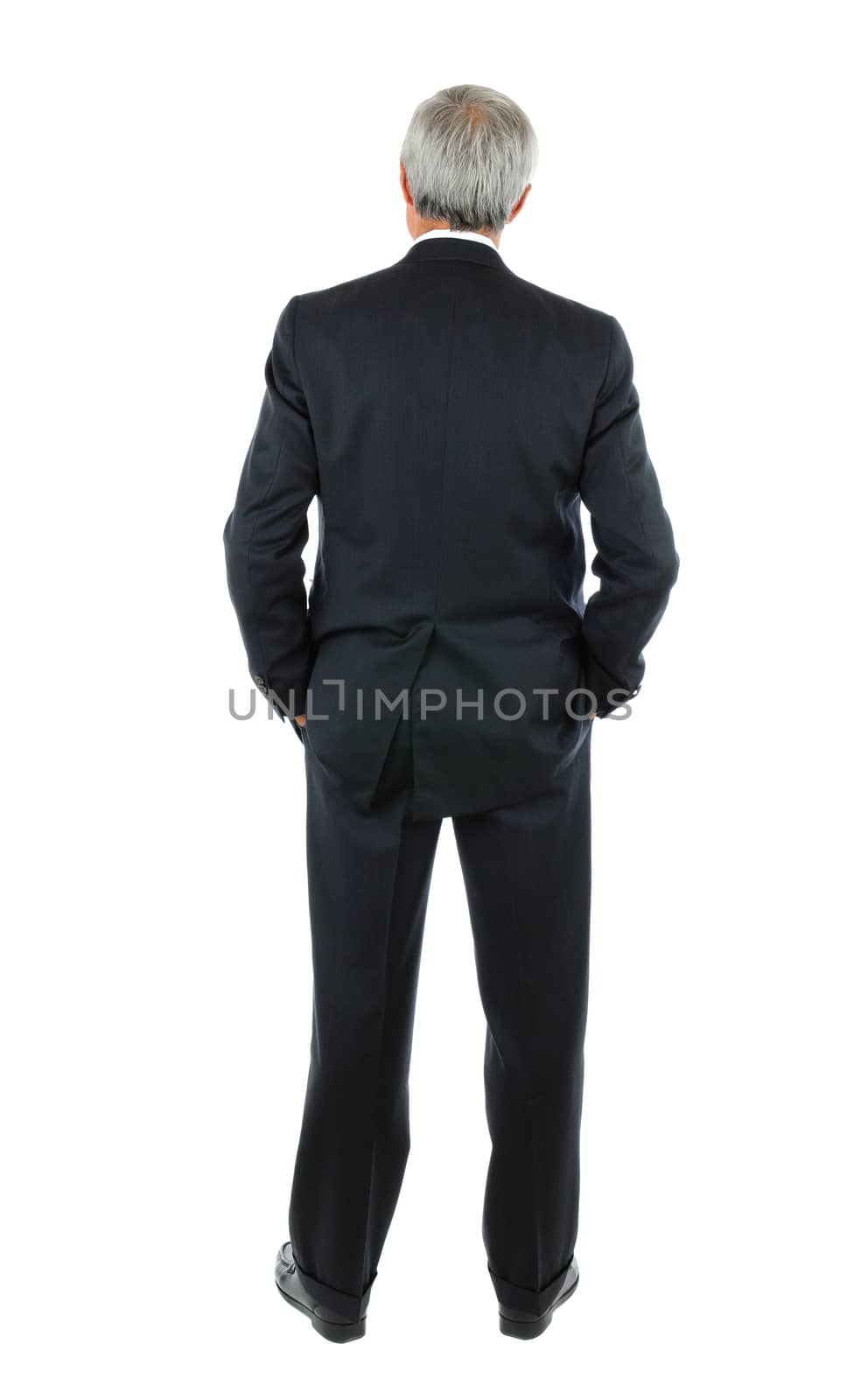 Businessman with hands in pocket from behind by sCukrov