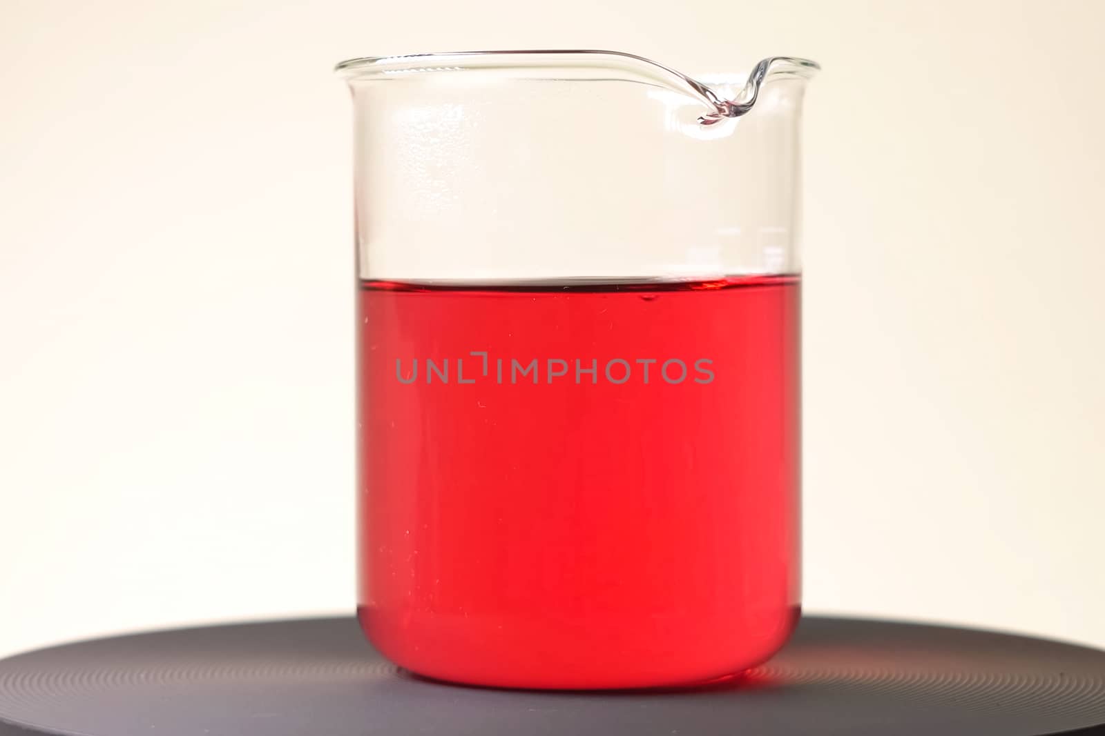 Red liquid in glass glass. Chemical experiments by DePo