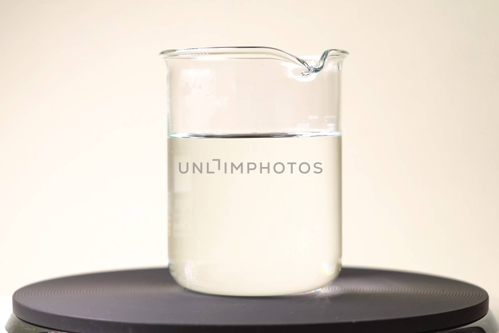 glass with a clear liquid. Chemical experiments in the laboratory. by DePo