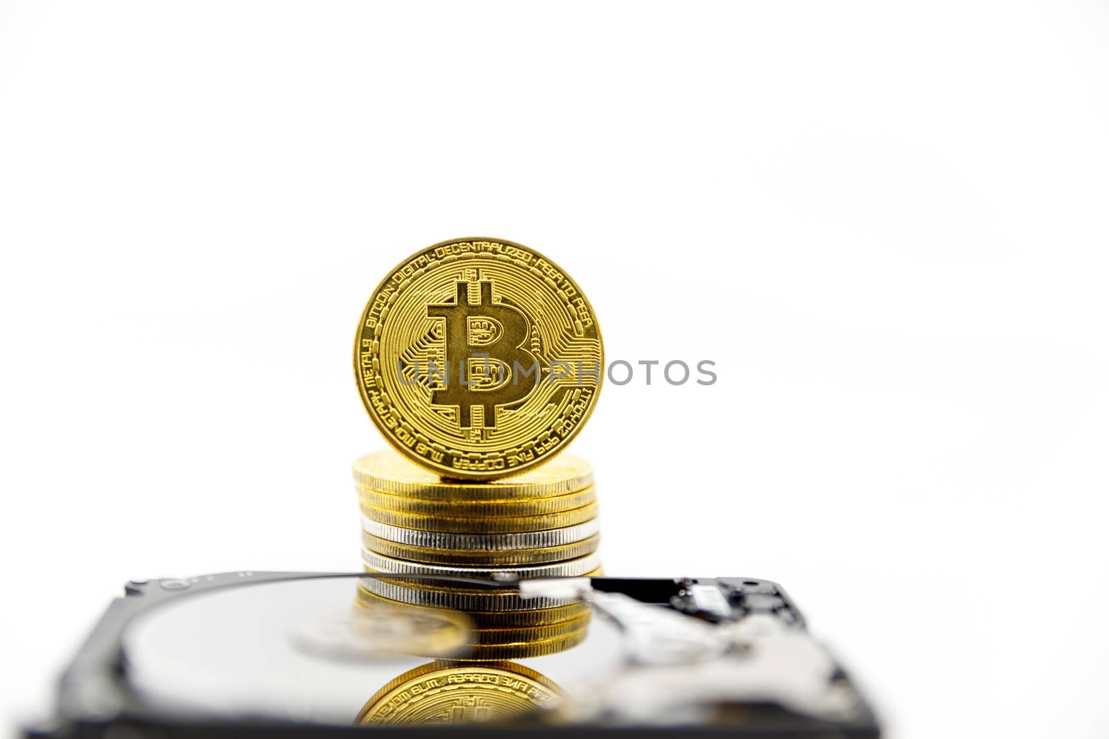 Stack of Gold bitcoin tokens on top of an open hard drive.Worldwide virtual internet cryptocurrency,digital payment system.Concept Digital coin money crypto currency on bitcoin farm.Copy space