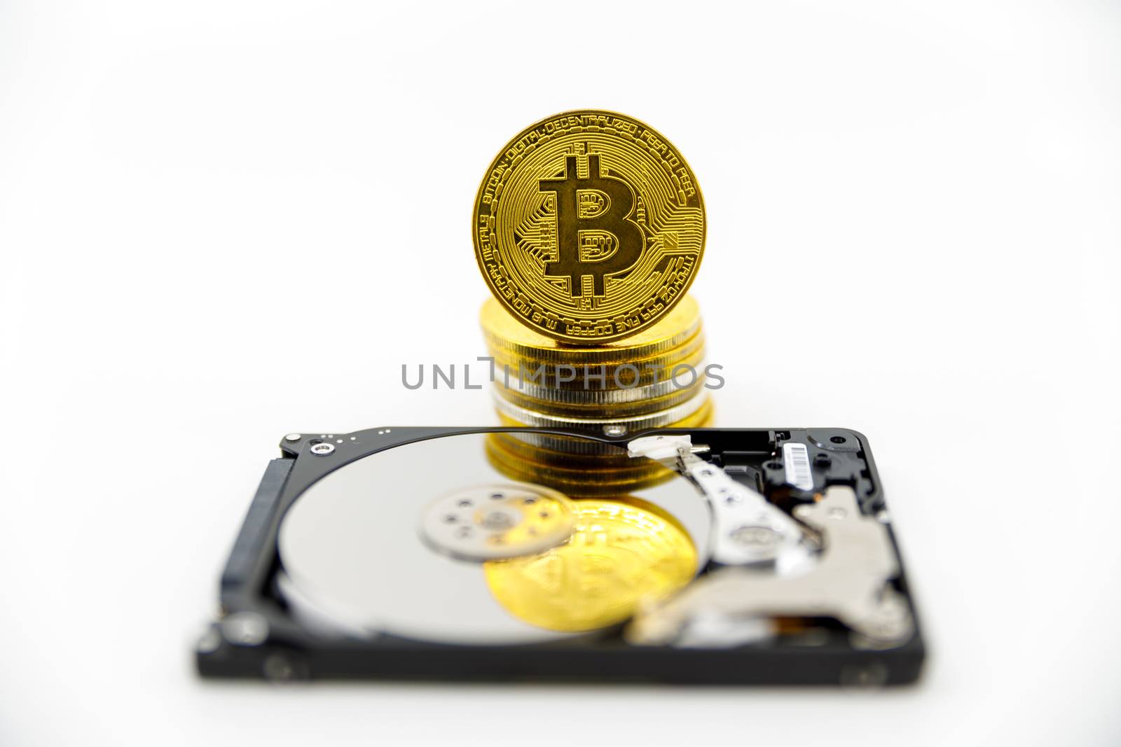 Stack of Gold bitcoin tokens on top of an open hard drive.Worldwide virtual internet cryptocurrency,digital payment system.Concept Digital coin money crypto currency on bitcoin farm.Copy space