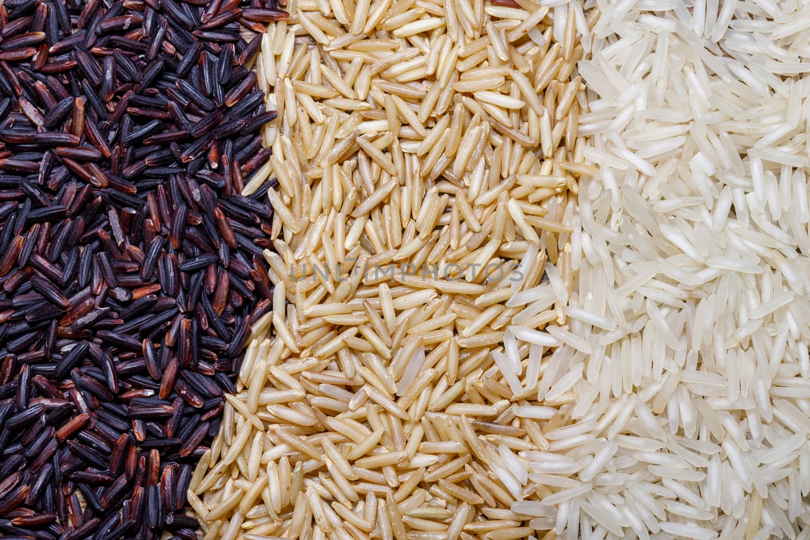 Black wild rice, brown wild rice and white jasmine rice flat lay. Creative layout. Food concept