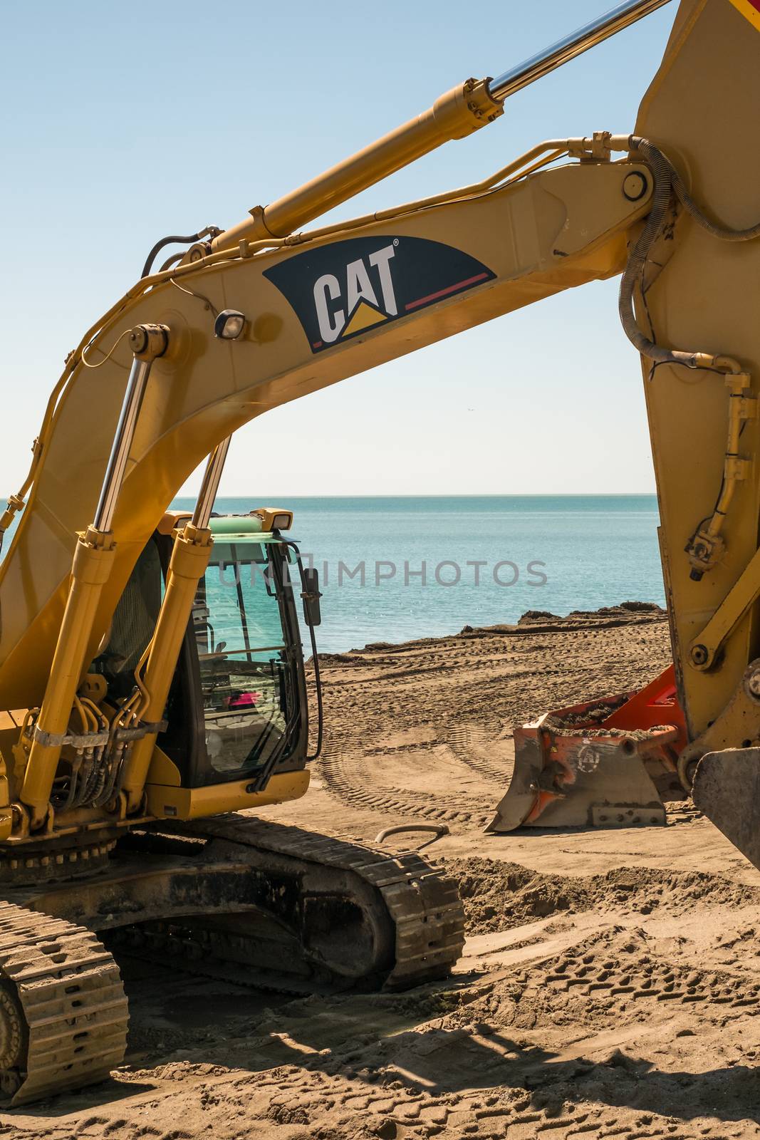 Malaga, Spain - April 14, 2018. Excavator on the beach
