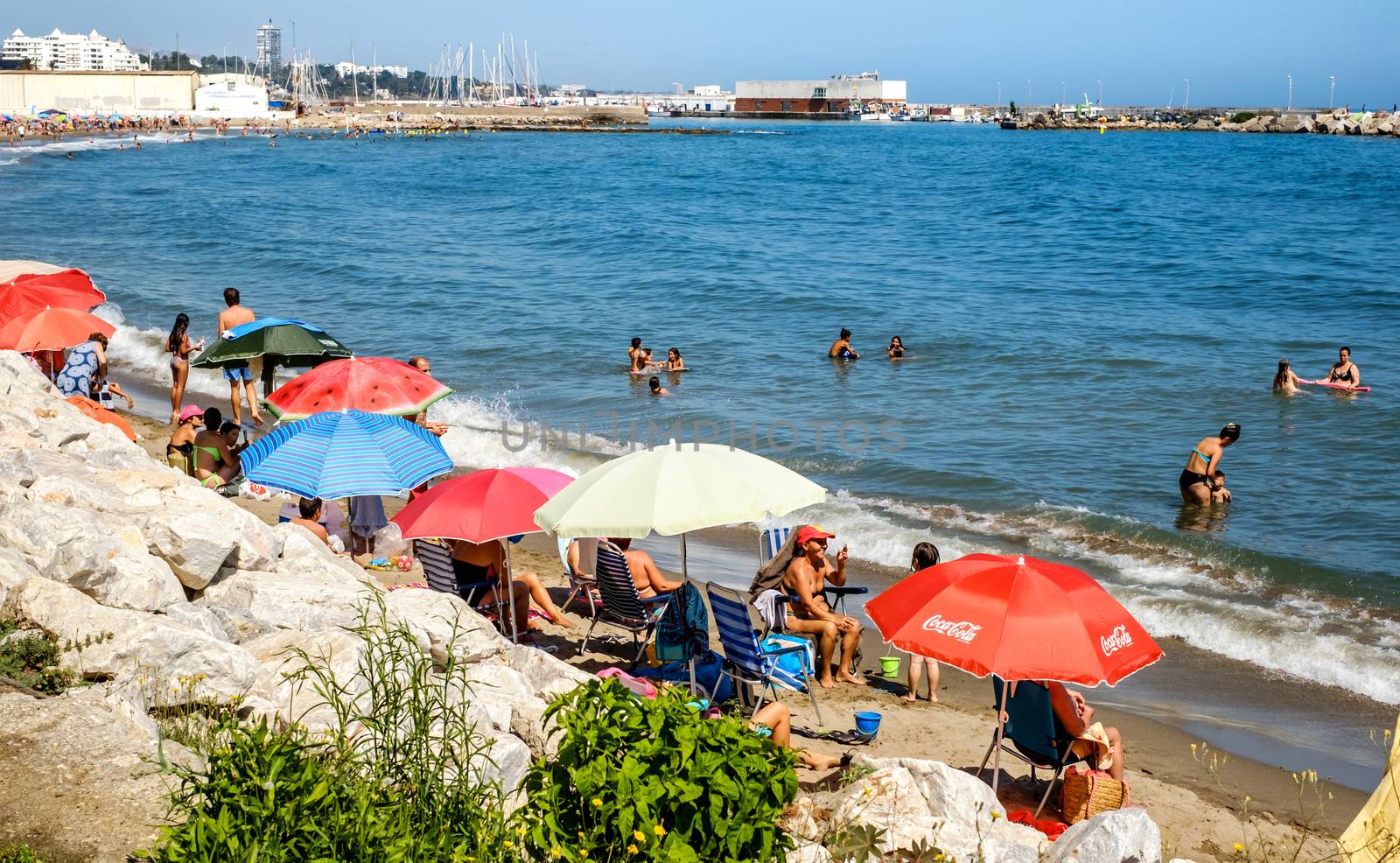 Holidaymakers sunbathing on Marbella beach by Roberto