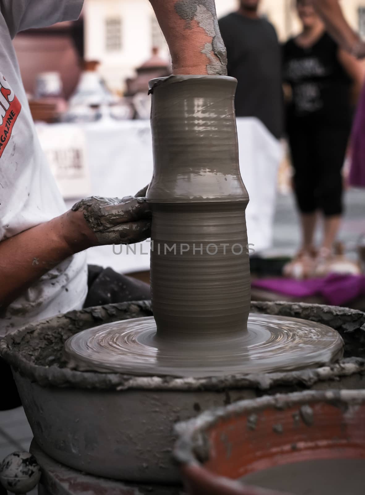 Sibiu City, Romania - 31 August 2019. Hands of a potter shaping a clay pot on a potter's wheel at the potters fair from Sibiu, Romania