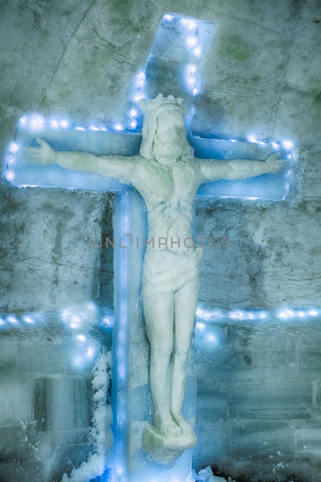 Ice Hotel - Balea Lake Romania - January 24 2019. ice sculpture represented on Jesus crucified on the cross in the ice hotel on the frozen glacier Balea lake in Fagaras Mountains, Transylvania, Romania