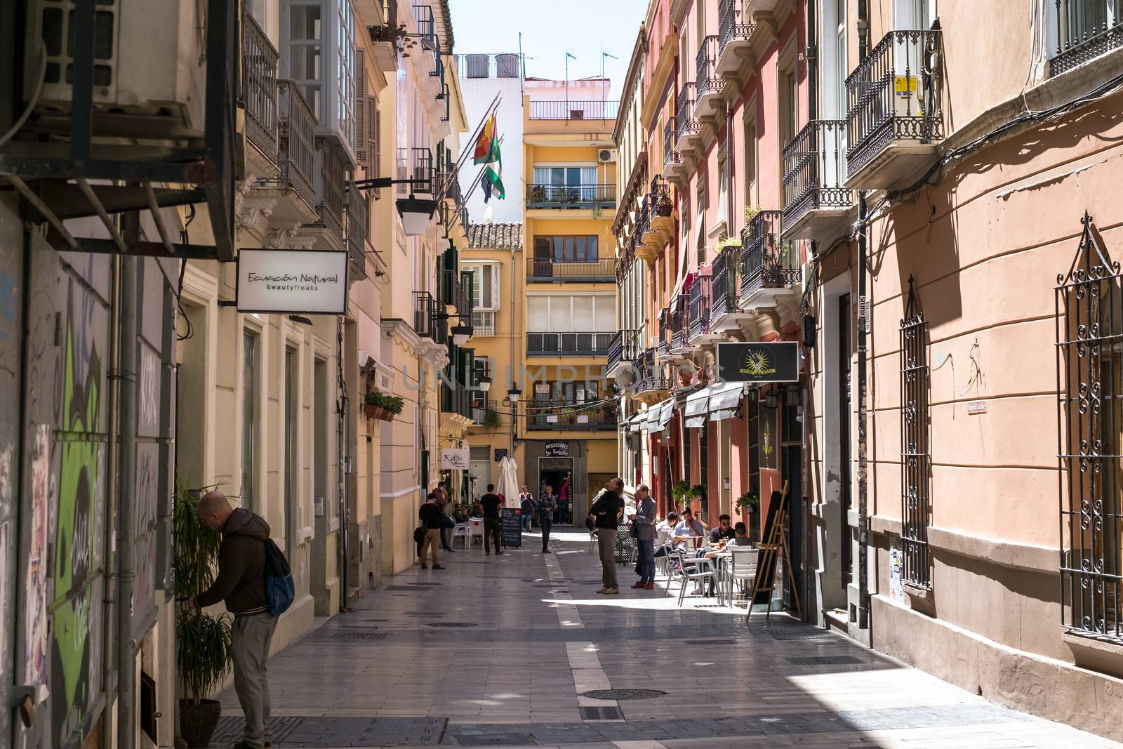 Malaga, Spain - April 14, 2018. Old street of Malaga with tourist