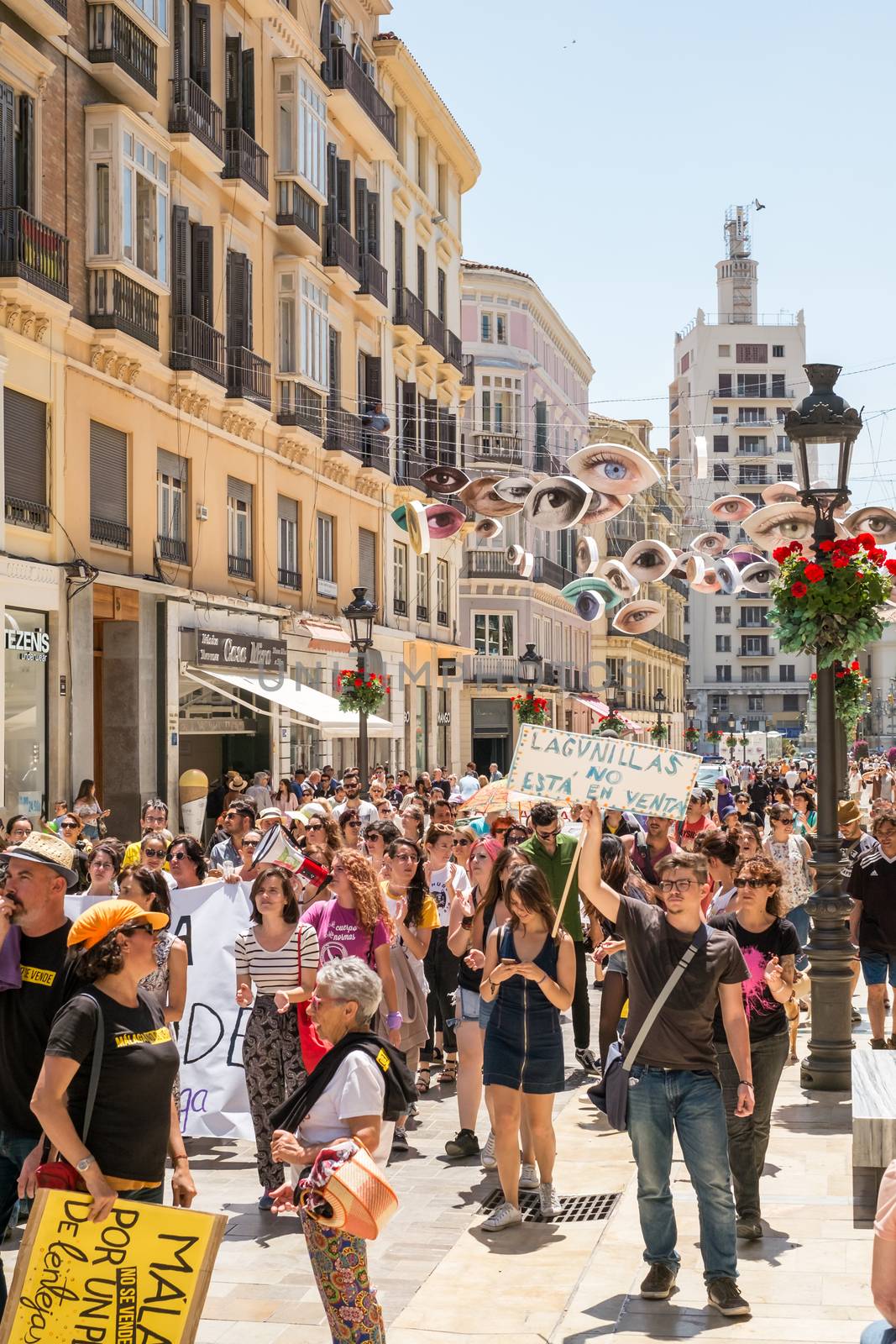 Malaga, Spain - May 12, 2018. People members of the Malaga No Se Vende platform, manifesting on the Marques de Larios pedestrian, in the historic center of Malaga, Spain