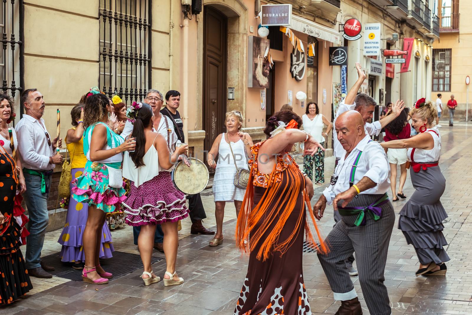 Malaga, Spain - August 12, 2018. People having fun on the street at the Feria de Malaga, an annual event that takes place in mid-August and is one of the largest fiestas in Spain