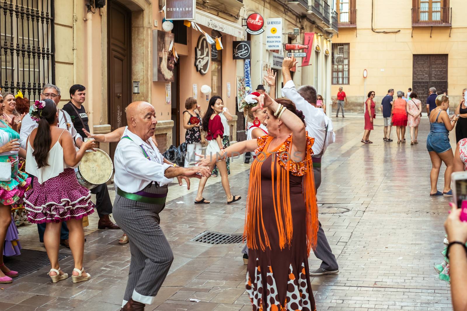 Malaga, Spain - August 12, 2018. People having fun on the street at the Feria de Malaga, an annual event that takes place in mid-August and is one of the largest fiestas in Spain