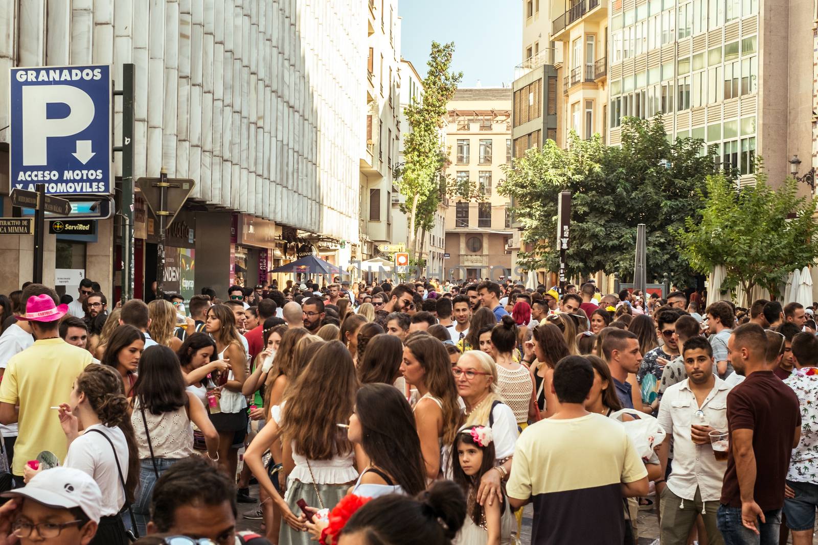 Malaga, Spain - August 13, 2018. People having fun on the street at the Feria de Malaga, an annual event that takes place in mid-August and is one of the largest fiestas in Spain