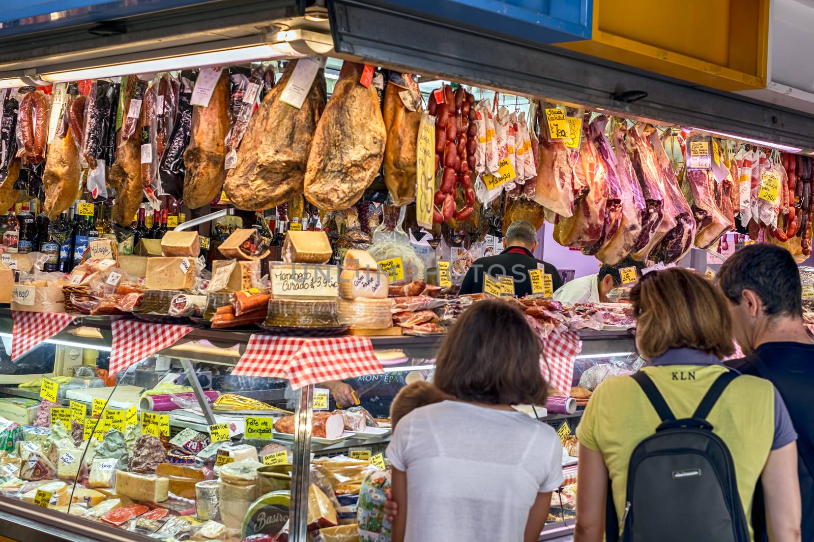 Malaga, Spain - August 04, 2018. Olive, Jamon iberico, dry fruits, sausages and other Spanish specialities at the market of Ataranzanas Central Market, Malaga, Spain