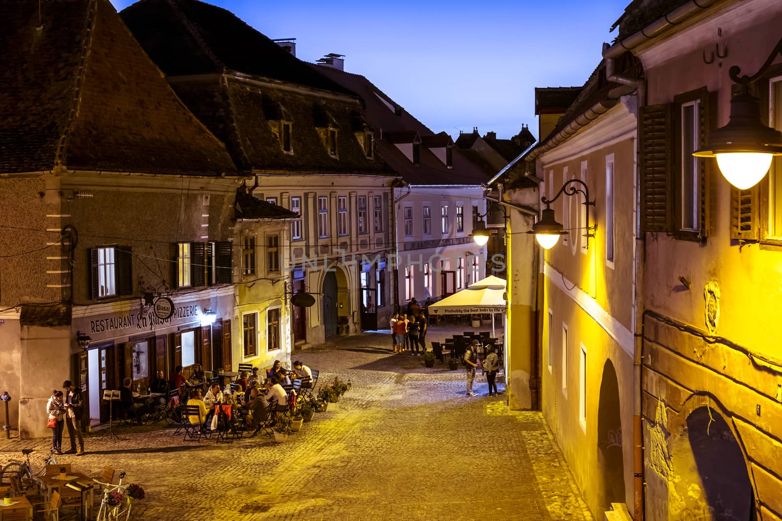 Sibiu city, Romania - September 23, 2018. People on the terrace at sunset in the old town Sibiu, Romania