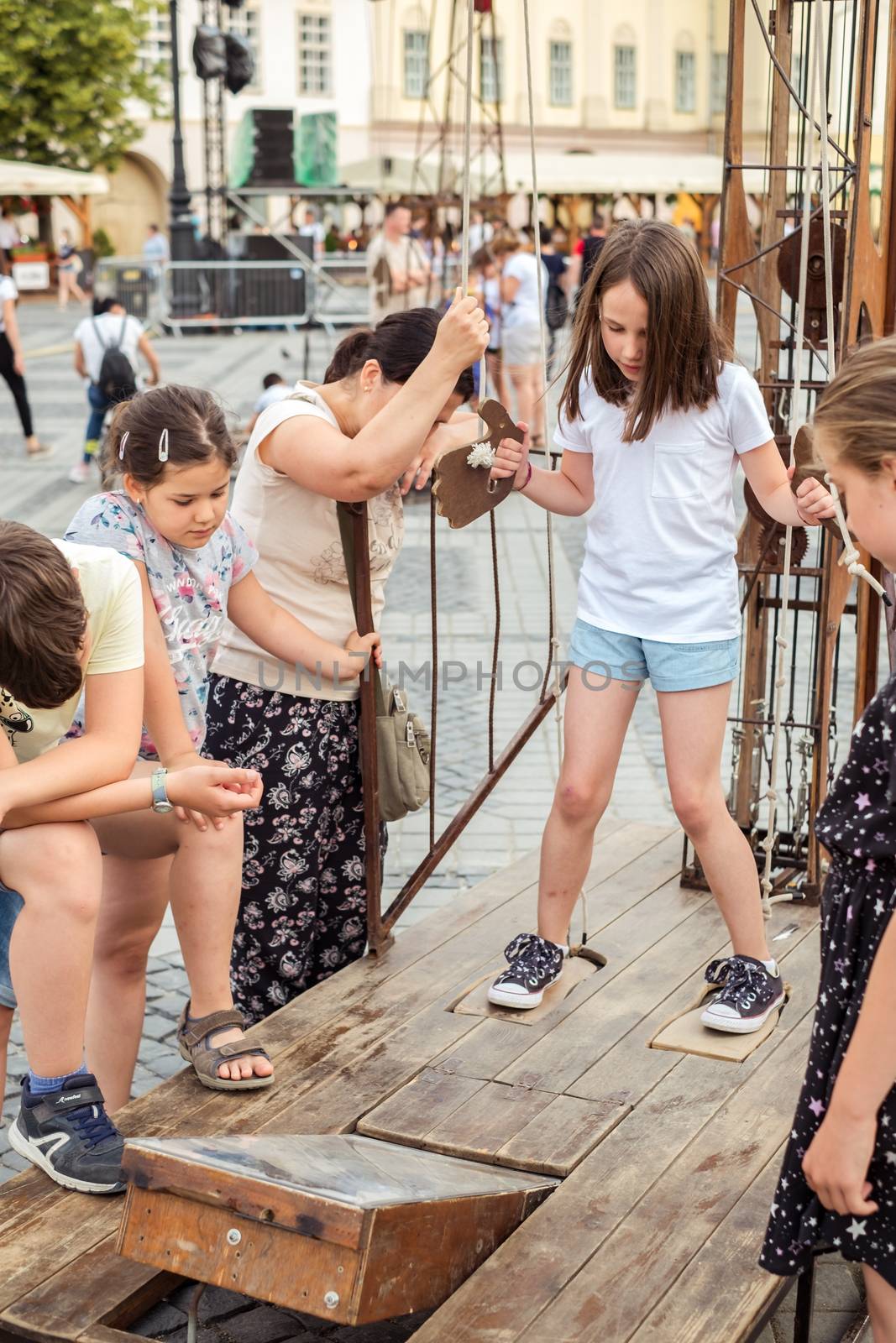 Sibiu City, Romania - 19 June 2019. children playing in The Strange Travel of Mr. Tonet from Spain, in the Big square, at the Sibiu International Theatre Festival from Sibiu, Romania.