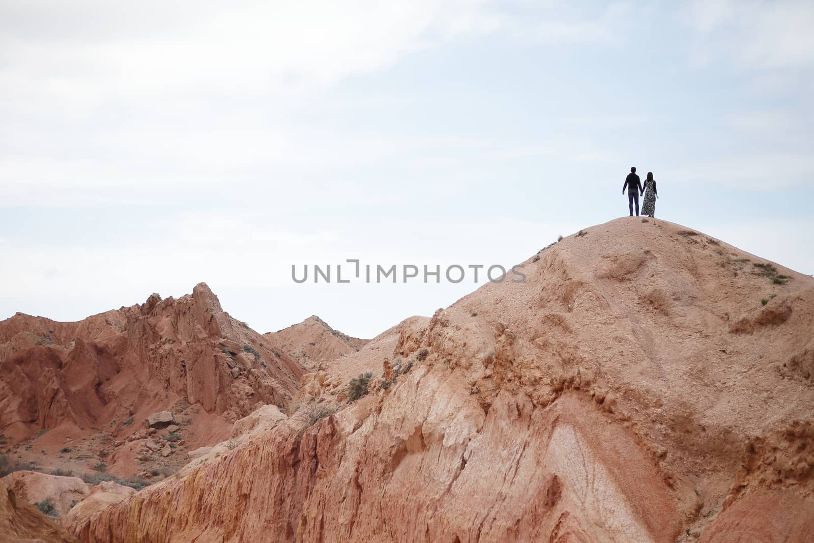 Couple on the top of the mountain. Beautiful mountain landscape. Wildlife of Kyrgyzstan. by selinsmo