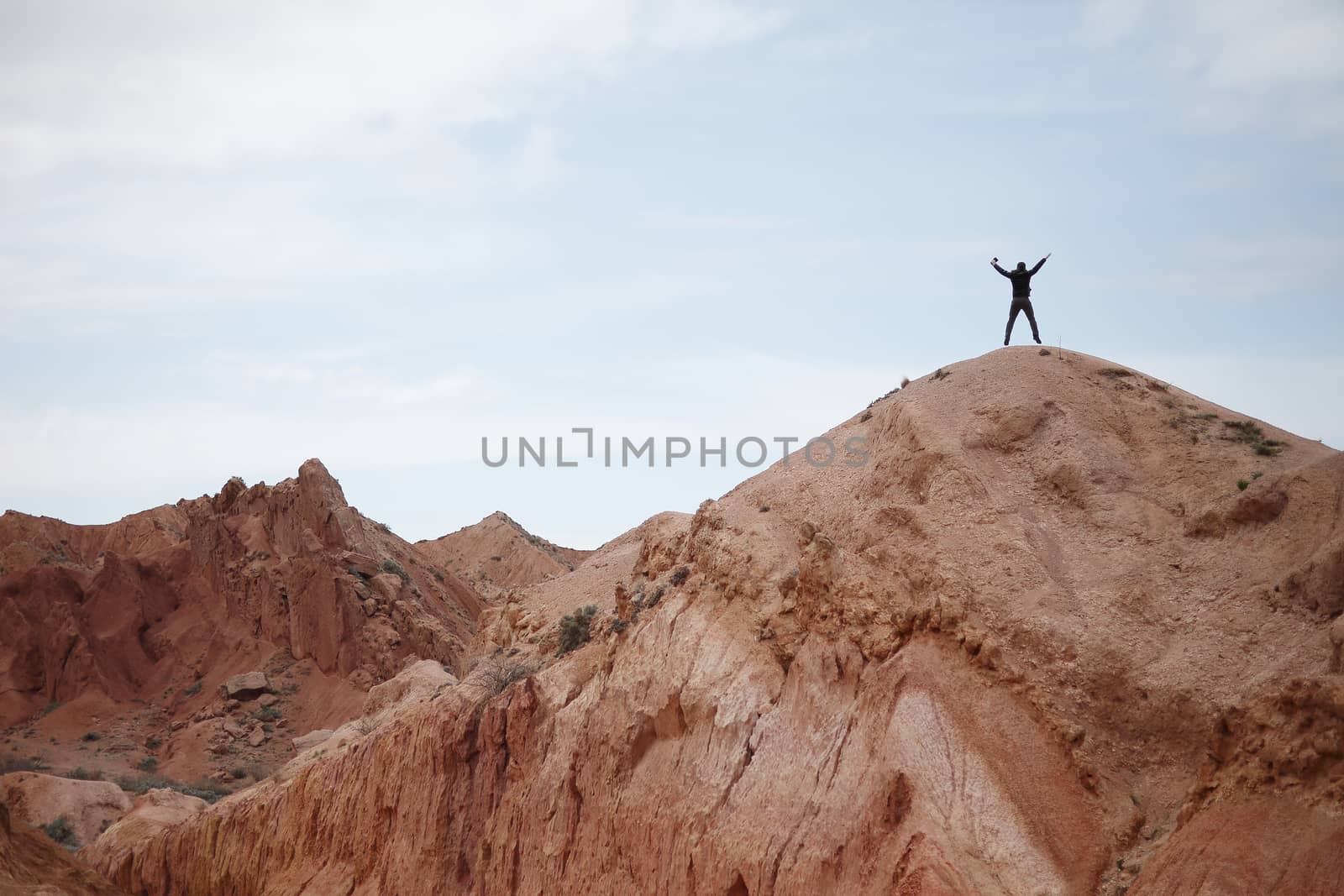 Man on the top of the mountain. Beautiful mountain landscape. Wildlife of Kyrgyzstan. by selinsmo