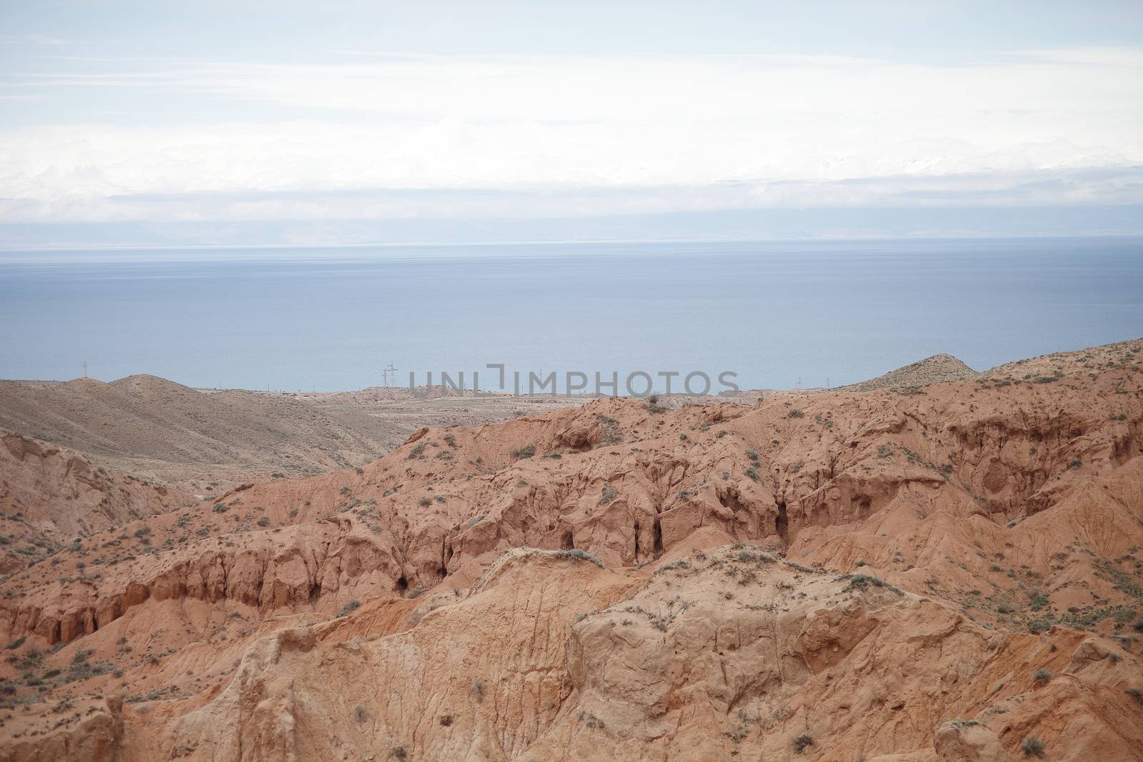 Beautiful mountain landscape. The shore of Lake Issyk-Kul. Wildlife of Kyrgyzstan. Clouds in the sky. by selinsmo
