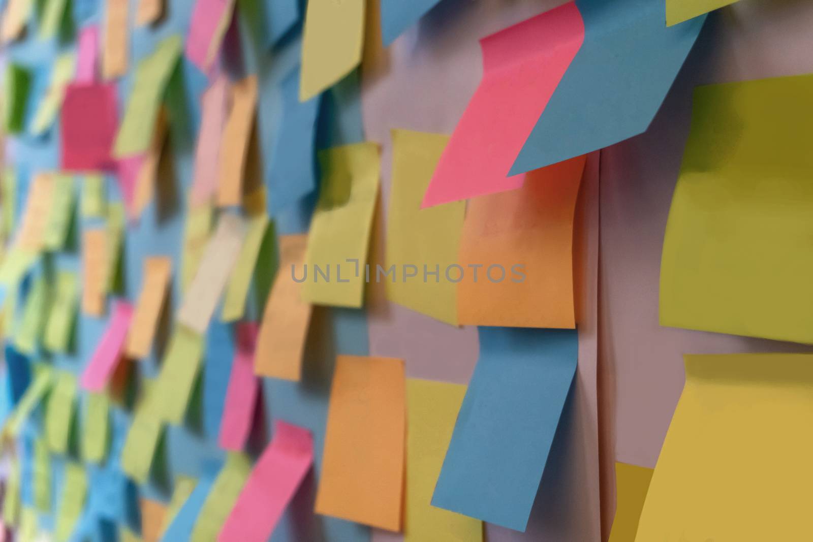 Colorful blank post-it on a white board for background.