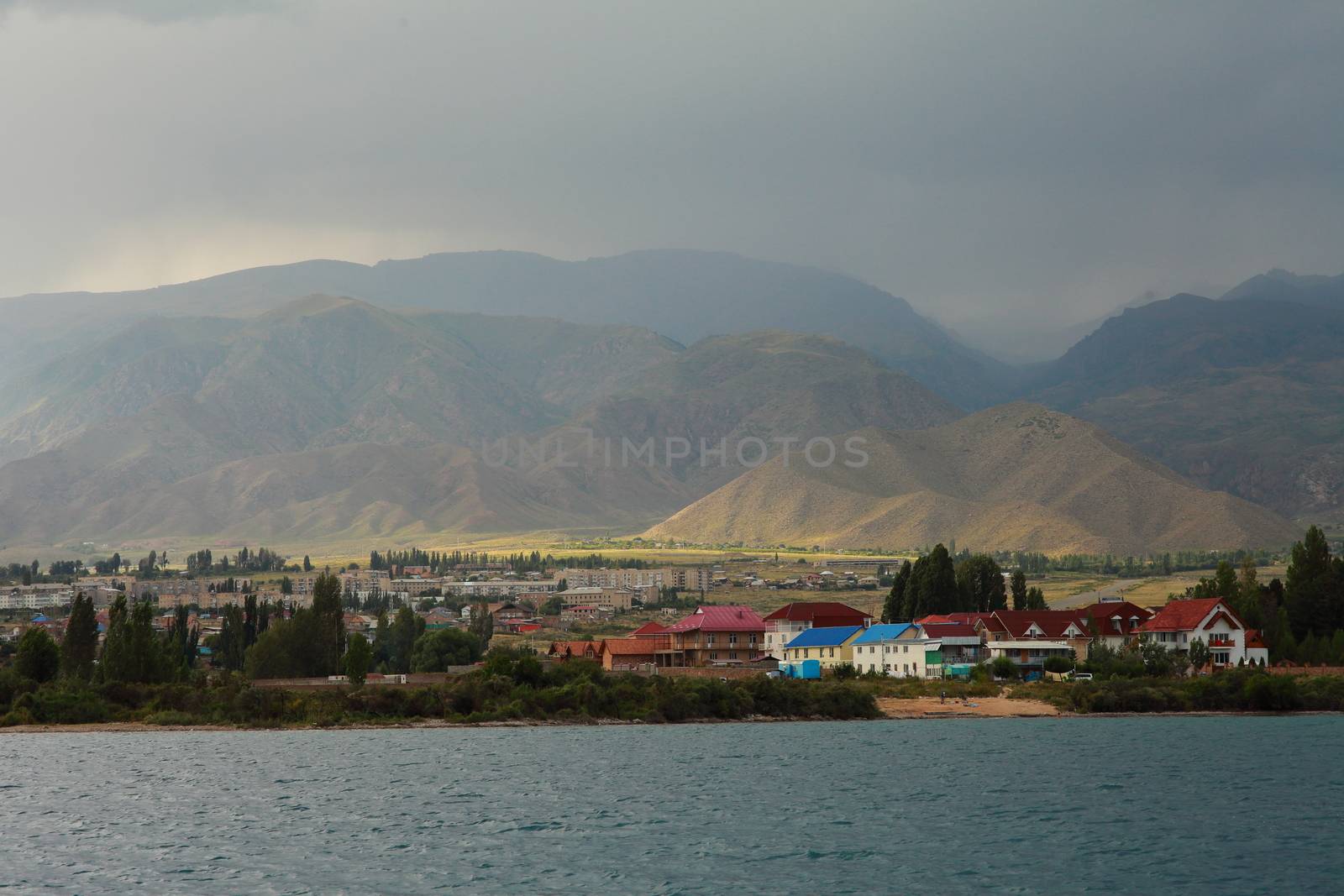 Beautiful mountain landscape. The shore of Lake Issyk-Kul. Wildlife of Kyrgyzstan. Clouds in the sky. High quality photo
